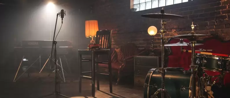 An empty chair, microphone, drum set and piano awaits a band at a Northern Colorado music venue