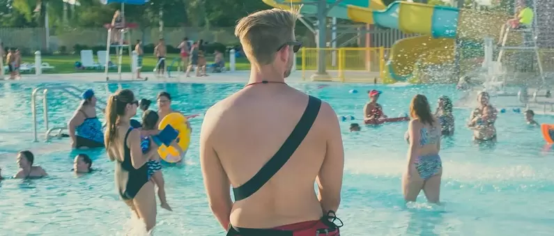 A male lifeguard stands duty at a Kansas, City, MO waterpark