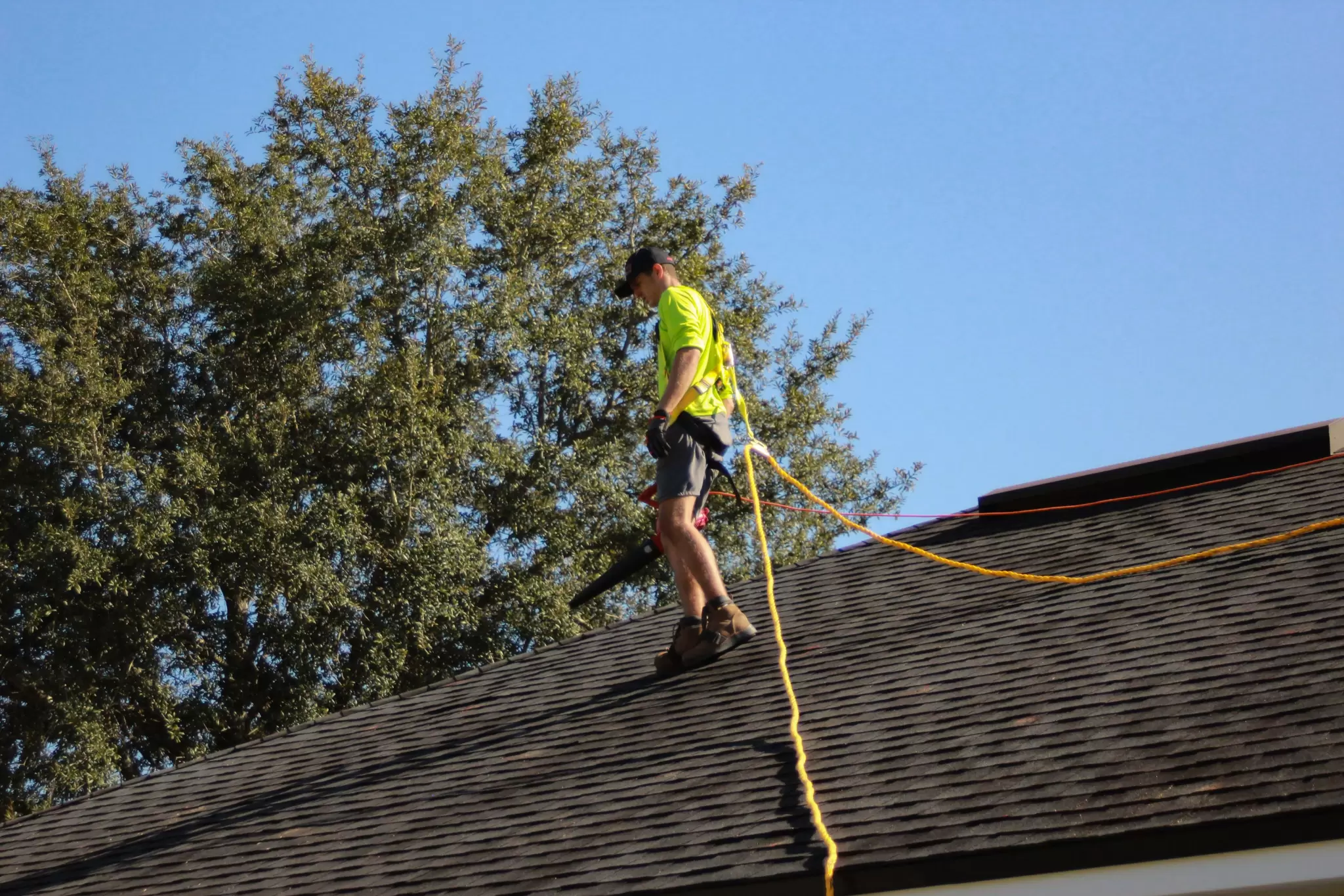 image of a roofer measuring the roof