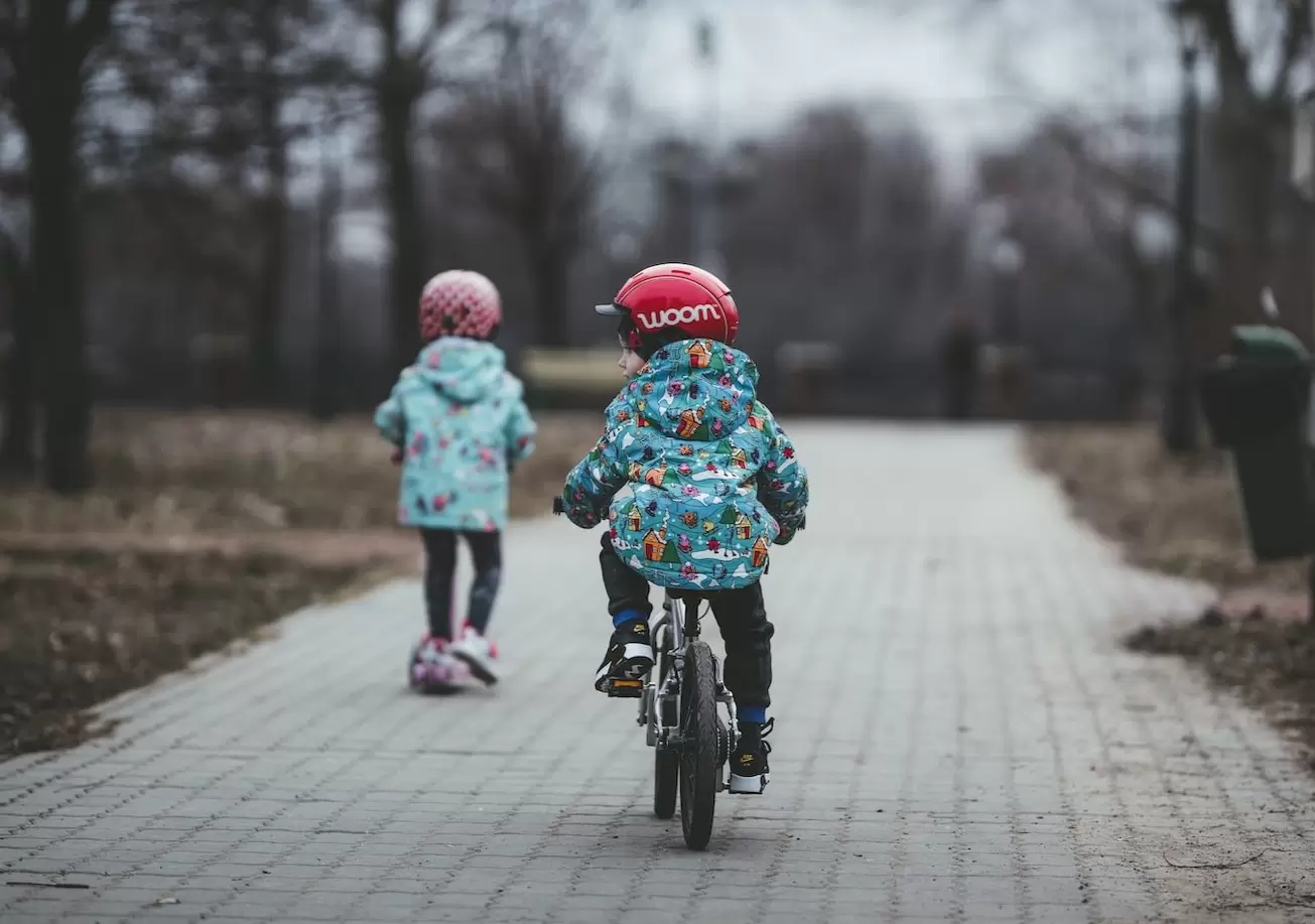 children riding bikes through Washington Park