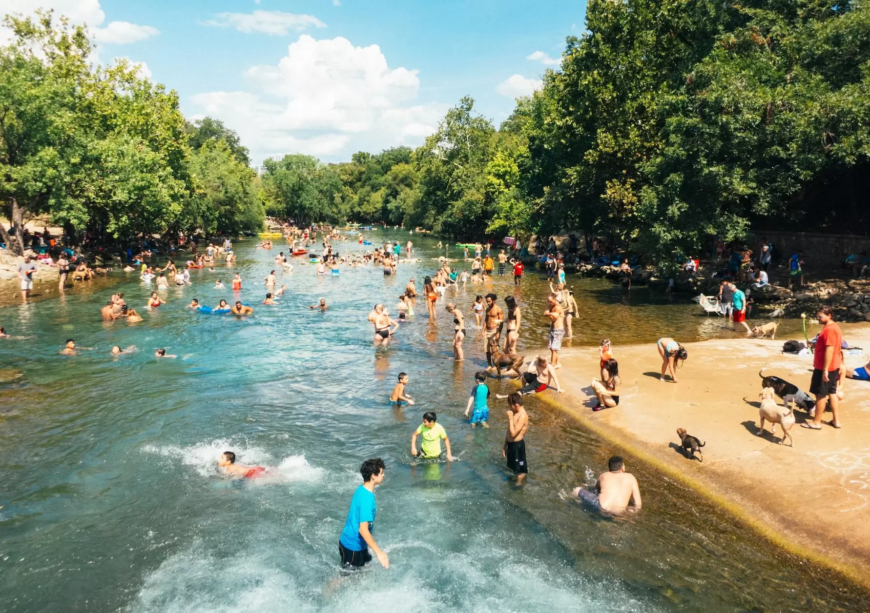 people enjoy a hot summer day on New Braunfels river