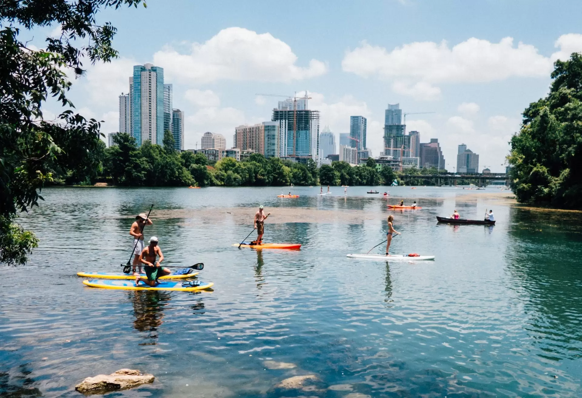 people riding paddle boards on the lake Austin TX